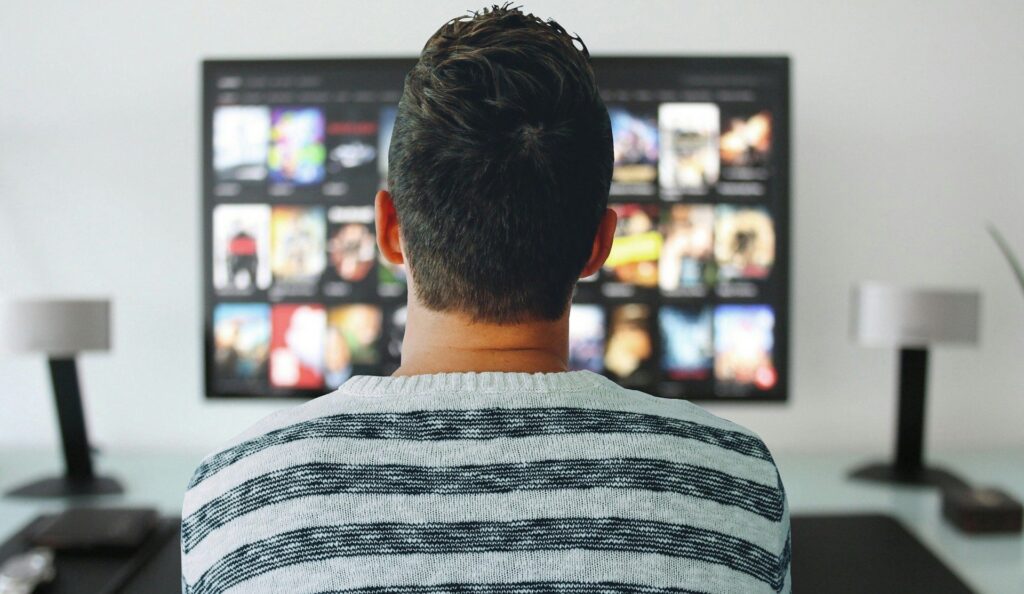 動画配信サービスをテレビで視聴する男性